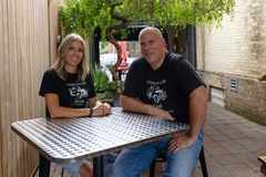 Kristen and Mike Norris seated together at a table